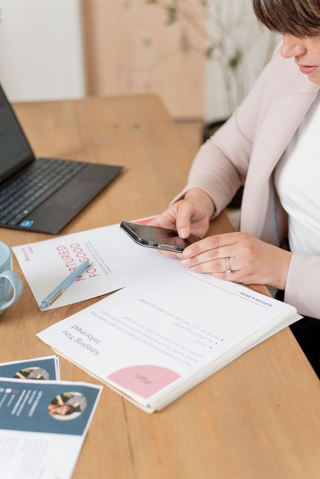 Three women sitting on couch looking at laptop