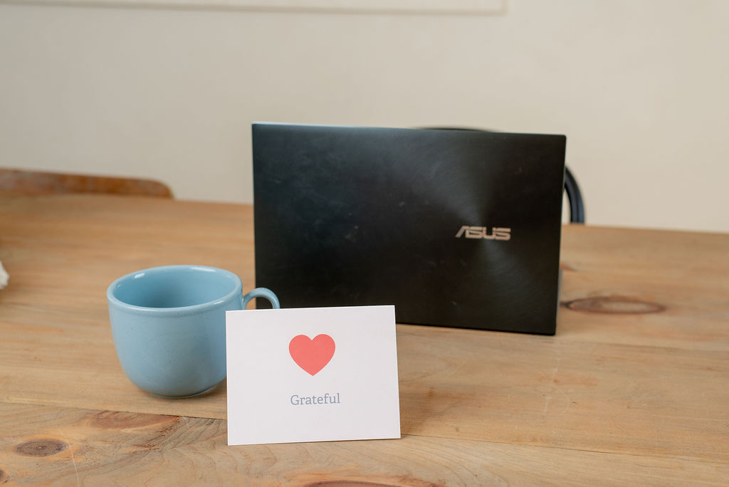 Three women sitting on couch looking at laptop